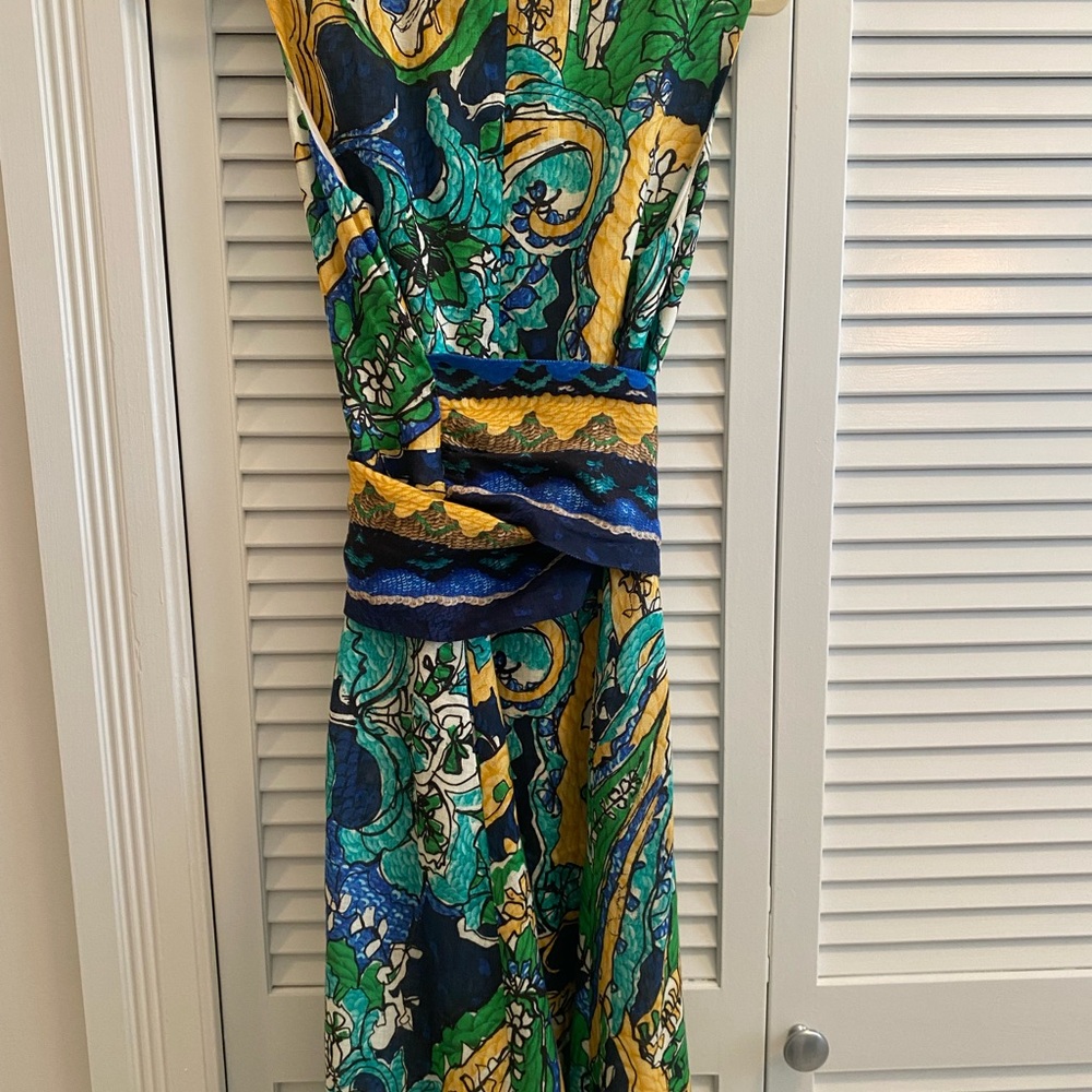 This dress is a fit and flair linen dress, a wrap sash, it is really flattering